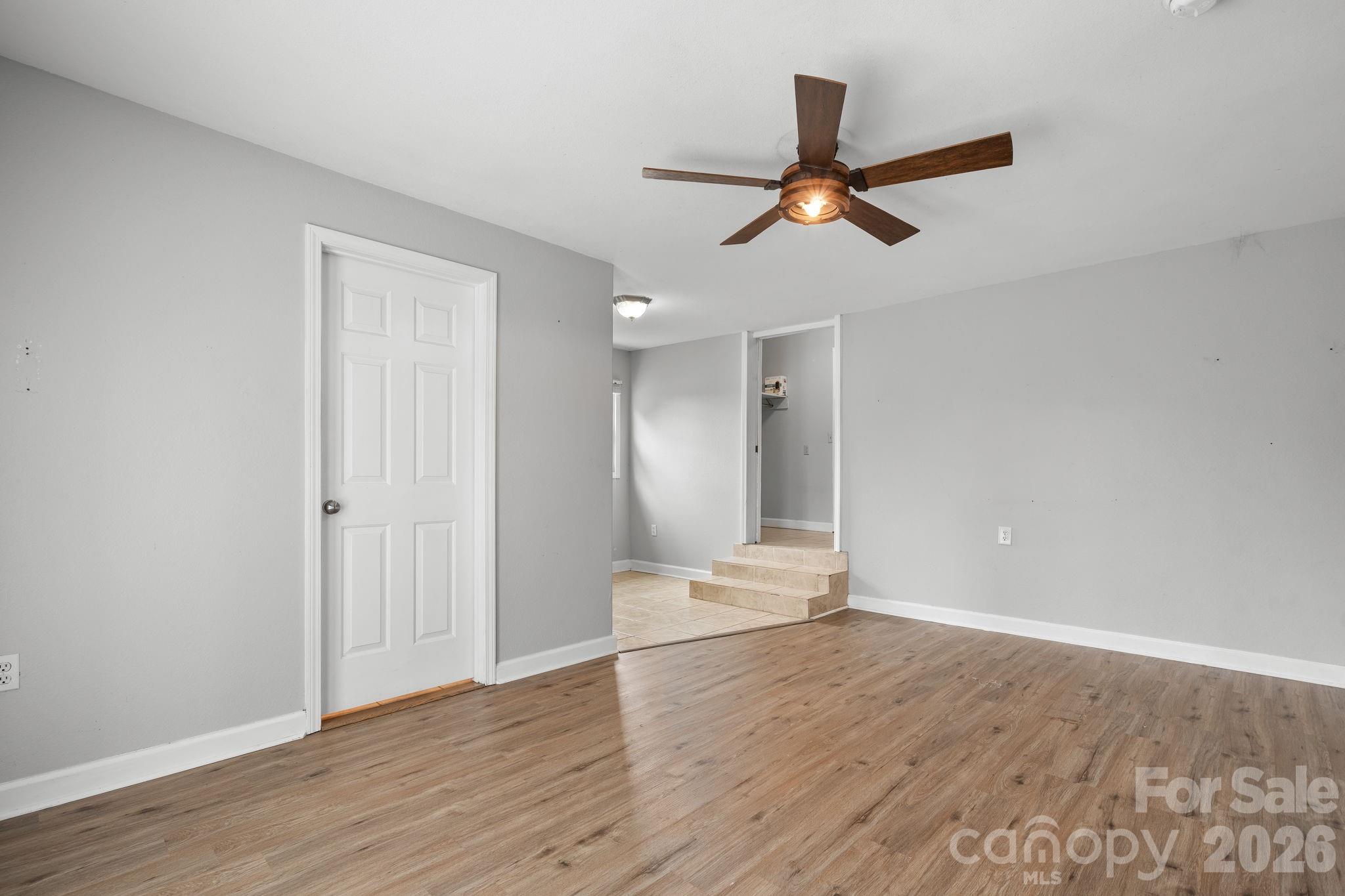 309 Sheldon Street Hudson, NC 28638 - Photo 11 of 35 a view of empty room with wooden floor and ceiling fan