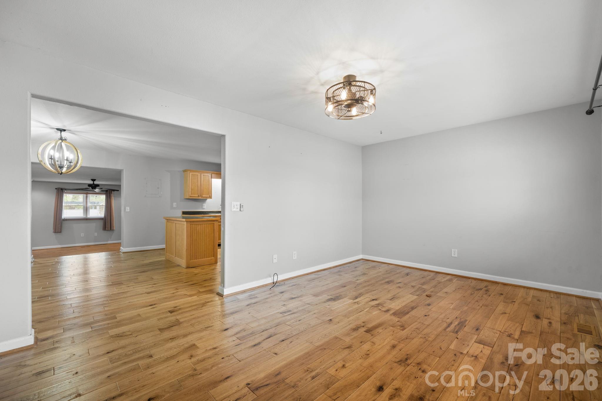 309 Sheldon Street Hudson, NC 28638 - Photo 3 of 35 wooden floor in an empty room with a window