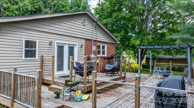 a view of backyard with outdoor seating and plants