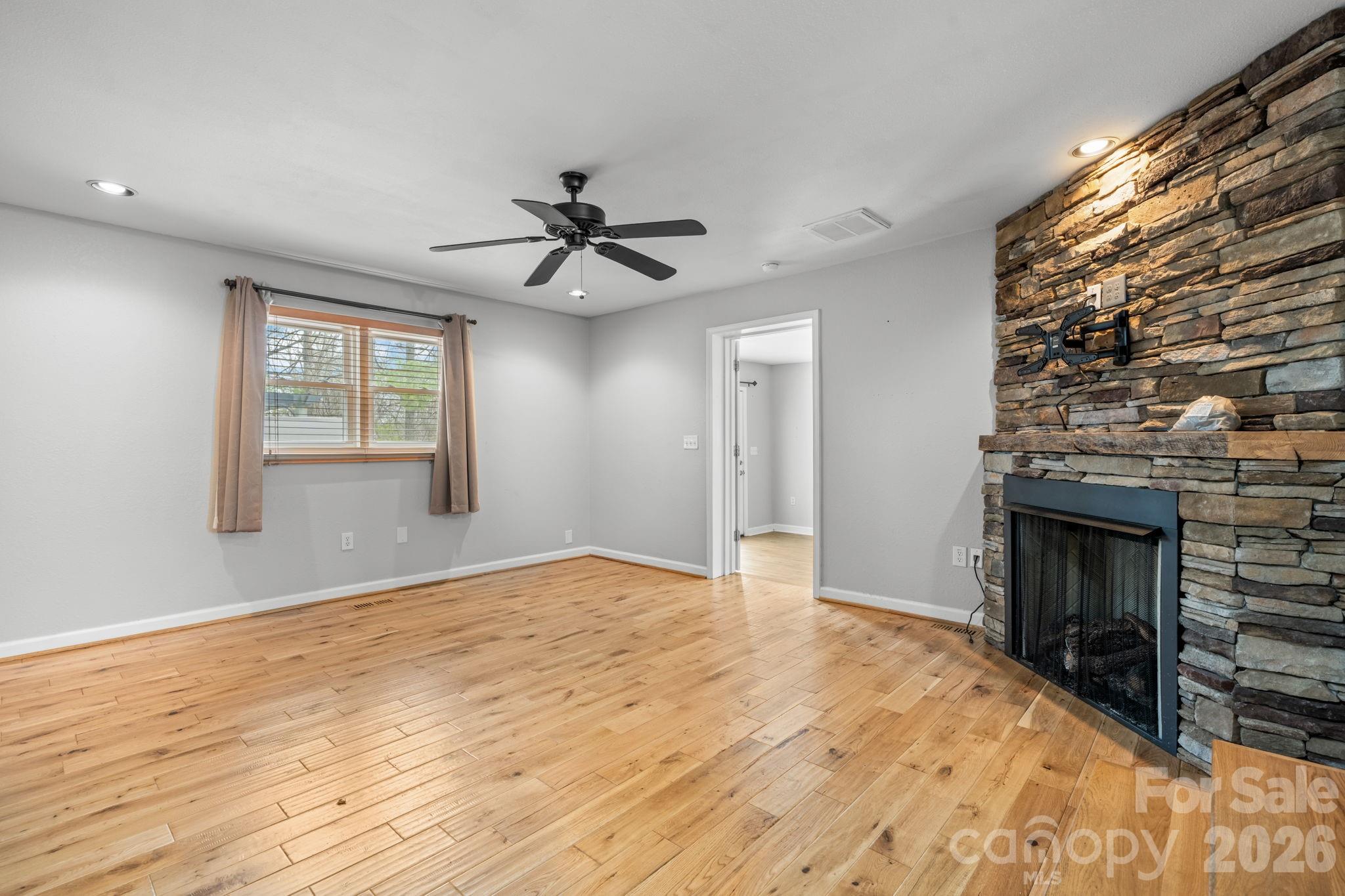 309 Sheldon Street Hudson, NC 28638 - Photo 8 of 35 a view of empty room with wooden floor and fireplace