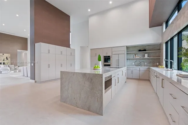 a large white kitchen with a large window