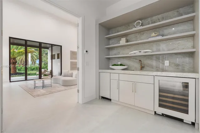 a living room with furniture and large windows with outer view