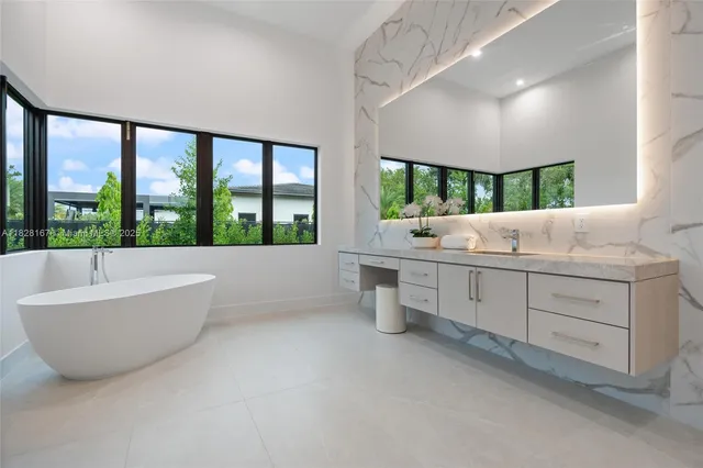 a white bath tub sitting in front of a window