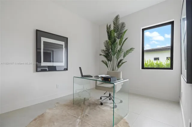 a work room with furniture and a flat screen tv