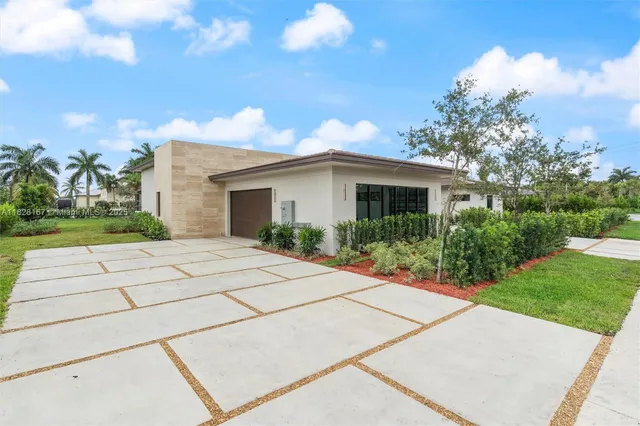 a front view of a house with a garden