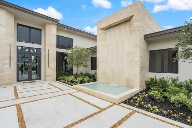 a front view of a house with garden