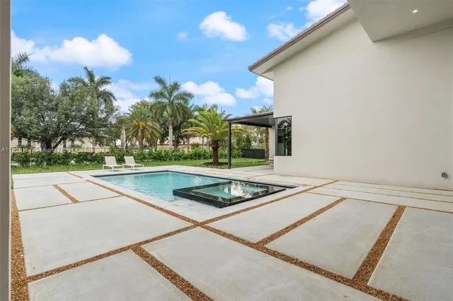 a view of a house with swimming pool and porch with furniture