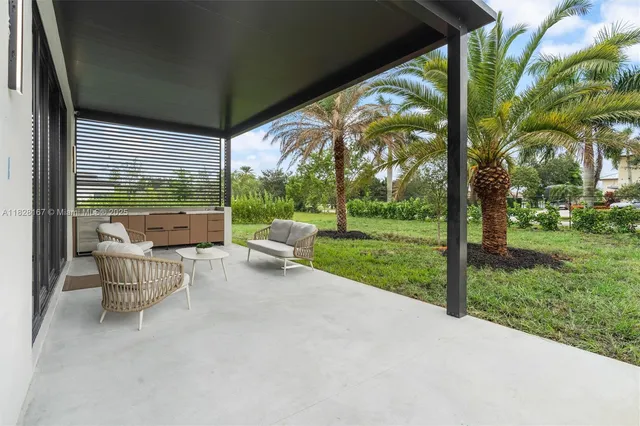 a view of backyard with outdoor seating and green space