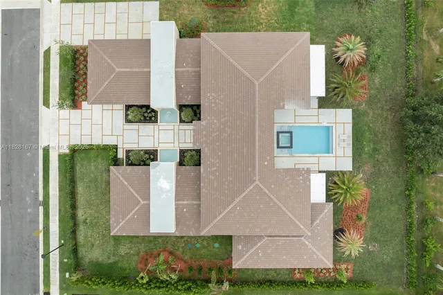 an aerial view of a house with a yard and lake view