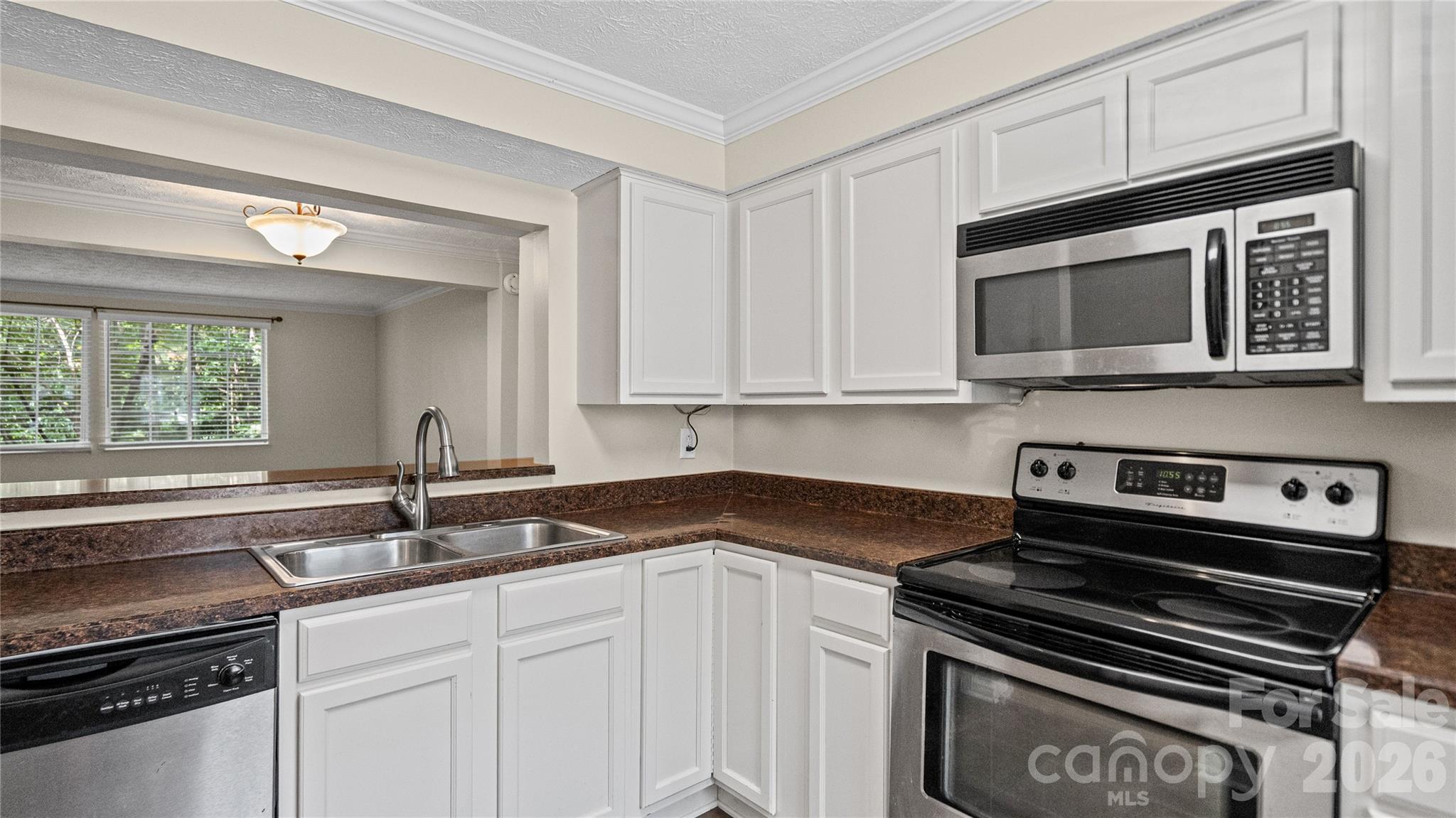 1231 Scaleybark Road Charlotte, NC 28209 - Photo 4 of 31 a kitchen with granite countertop a stove microwave and sink