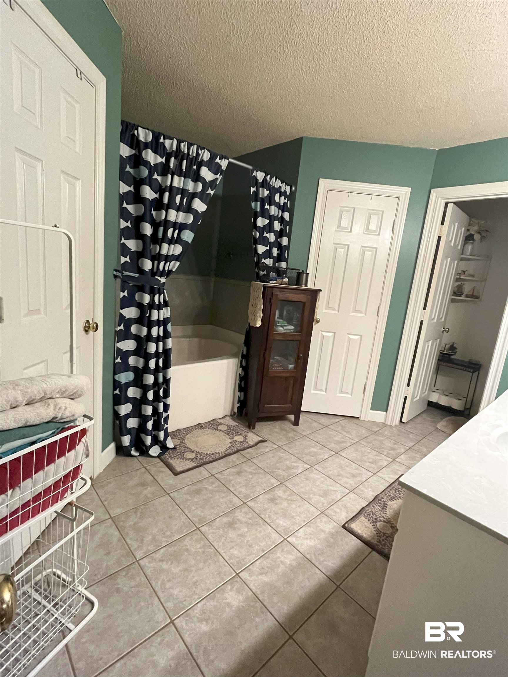 7851 Highway 98 Fairhope, AL 36532 - Photo 23 of 40 Bathroom with separate shower and bath, a textured ceiling, light tile patterned floors, and vanity