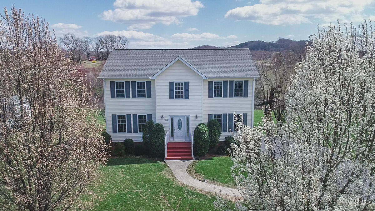 112 Aftons Meadow Road Vinton, VA 24179 - Photo 2 of 46 a front view of a house with a garden