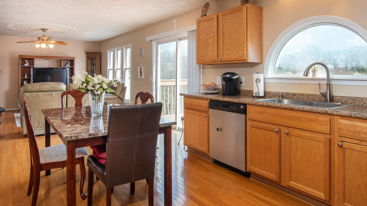 112 Aftons Meadow Road Vinton, VA 24179 - Photo 11 of 46 a kitchen with stainless steel appliances granite countertop a table and chairs