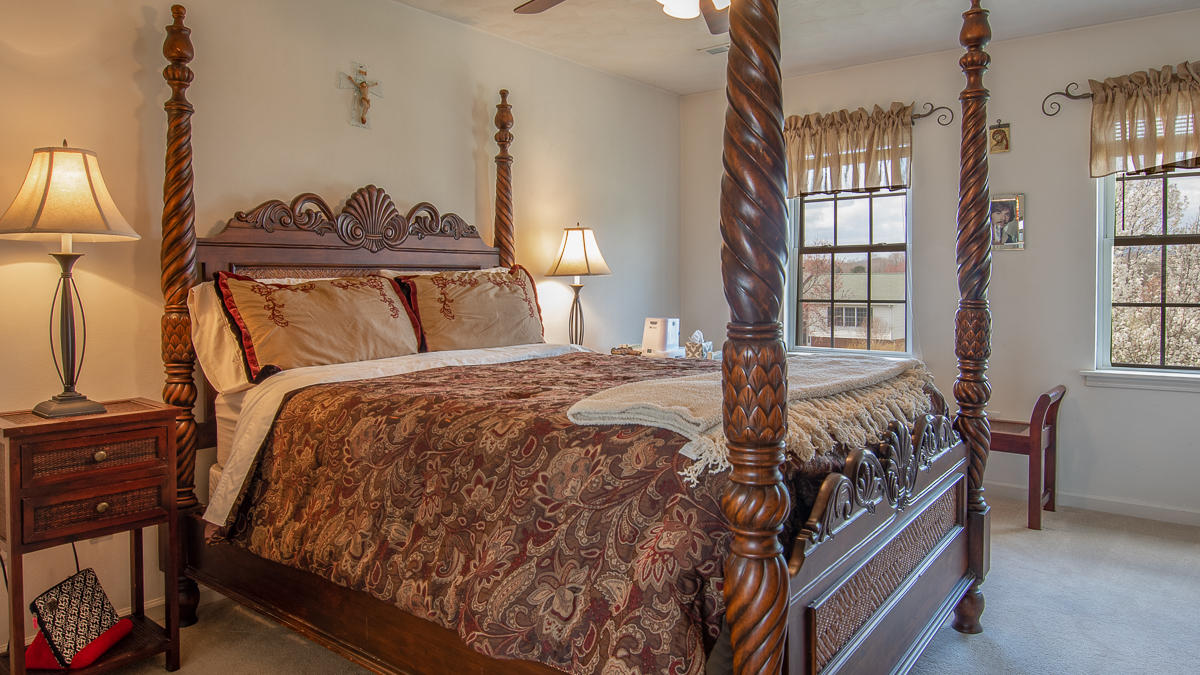 112 Aftons Meadow Road Vinton, VA 24179 - Photo 27 of 46 a bed sitting in a bedroom next to a window