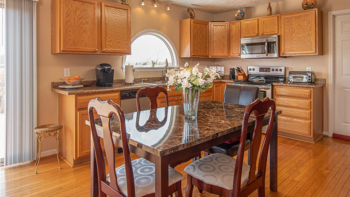 112 Aftons Meadow Road Vinton, VA 24179 - Photo 9 of 46 a kitchen with stainless steel appliances granite countertop a table chairs sink and cabinets