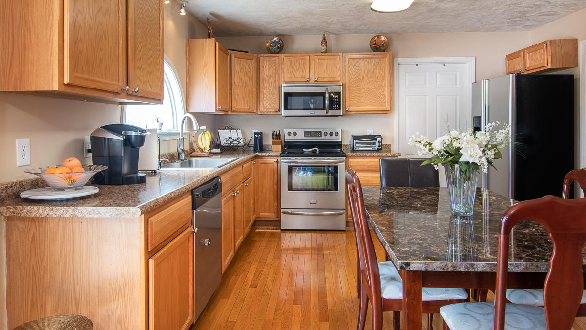 112 Aftons Meadow Road Vinton, VA 24179 - Photo 10 of 46 a kitchen with granite countertop stainless steel appliances and wooden cabinets