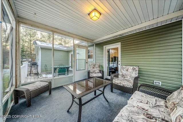 a balcony with furniture and a potted plant