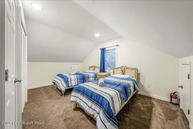 a bedroom with two beds and a couch