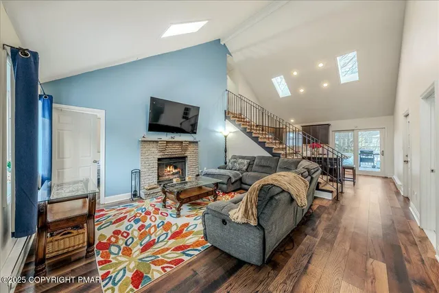 a living room with furniture fireplace and flat screen tv