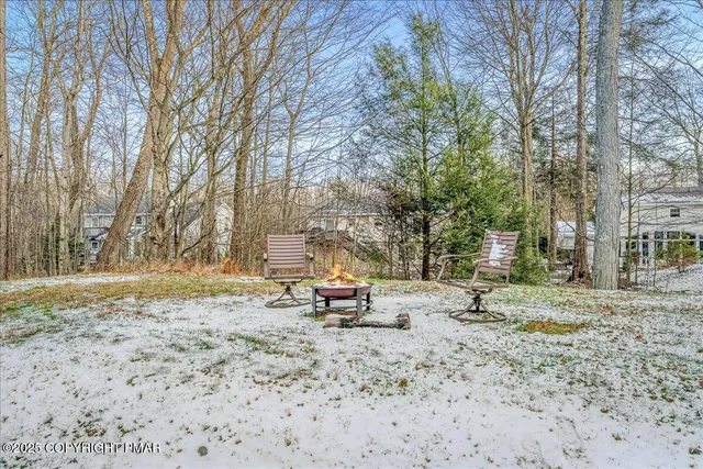 a backyard of a house with a stove and large trees