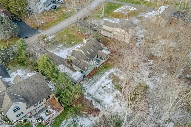 a aerial view of a house with a yard