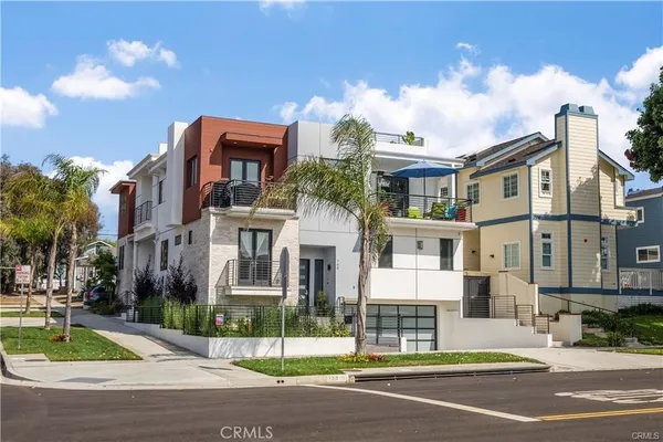 a front view of a residential apartment building with a yard