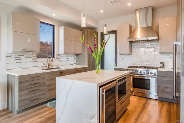 a kitchen with stainless steel appliances granite countertop a sink stove and refrigerator