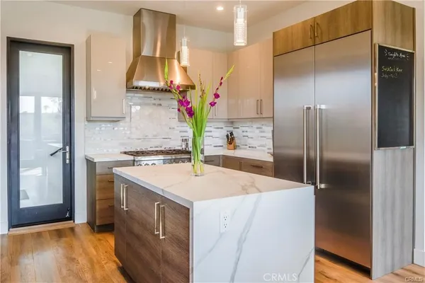 a kitchen with a refrigerator sink and stove