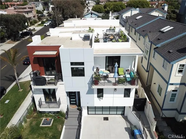 a view of residential houses with outdoor space and parking