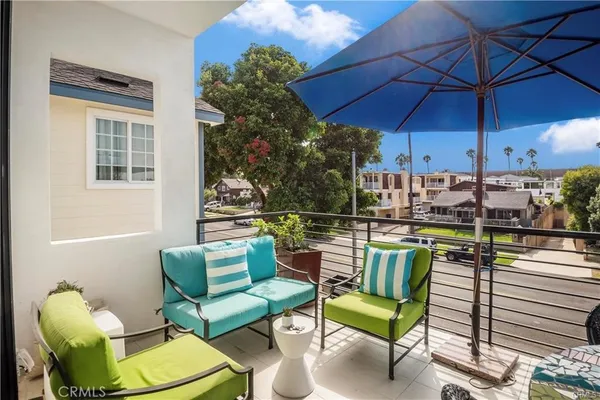 a view of a chairs and table in the balcony