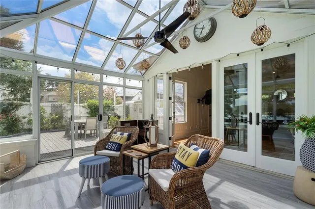 a view of a hallway with wooden floor and a bathroom