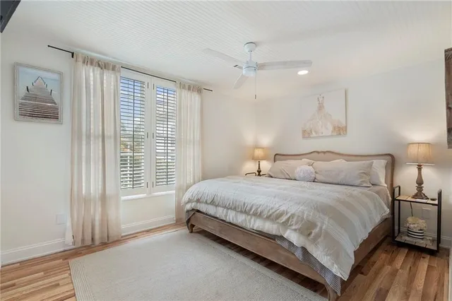 a bedroom with a bed and a potted plant