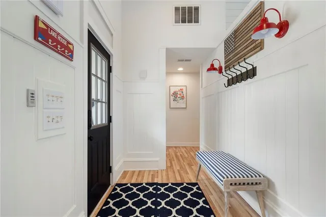 a living room with furniture kitchen view and a chandelier