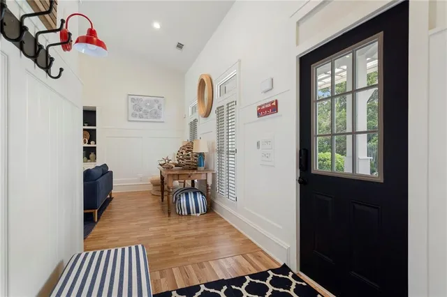a living room with furniture a fireplace and kitchen view