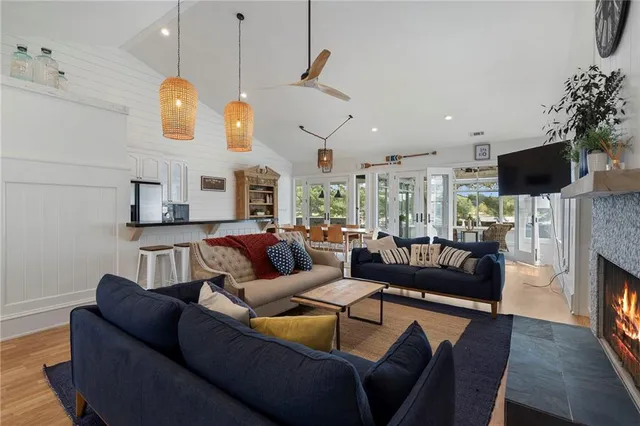 a living room with furniture large window and a fireplace
