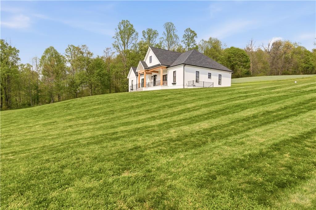 315 Stewarton Road Mill Run, PA 15464 - Photo 3 of 47 a house view with a garden space