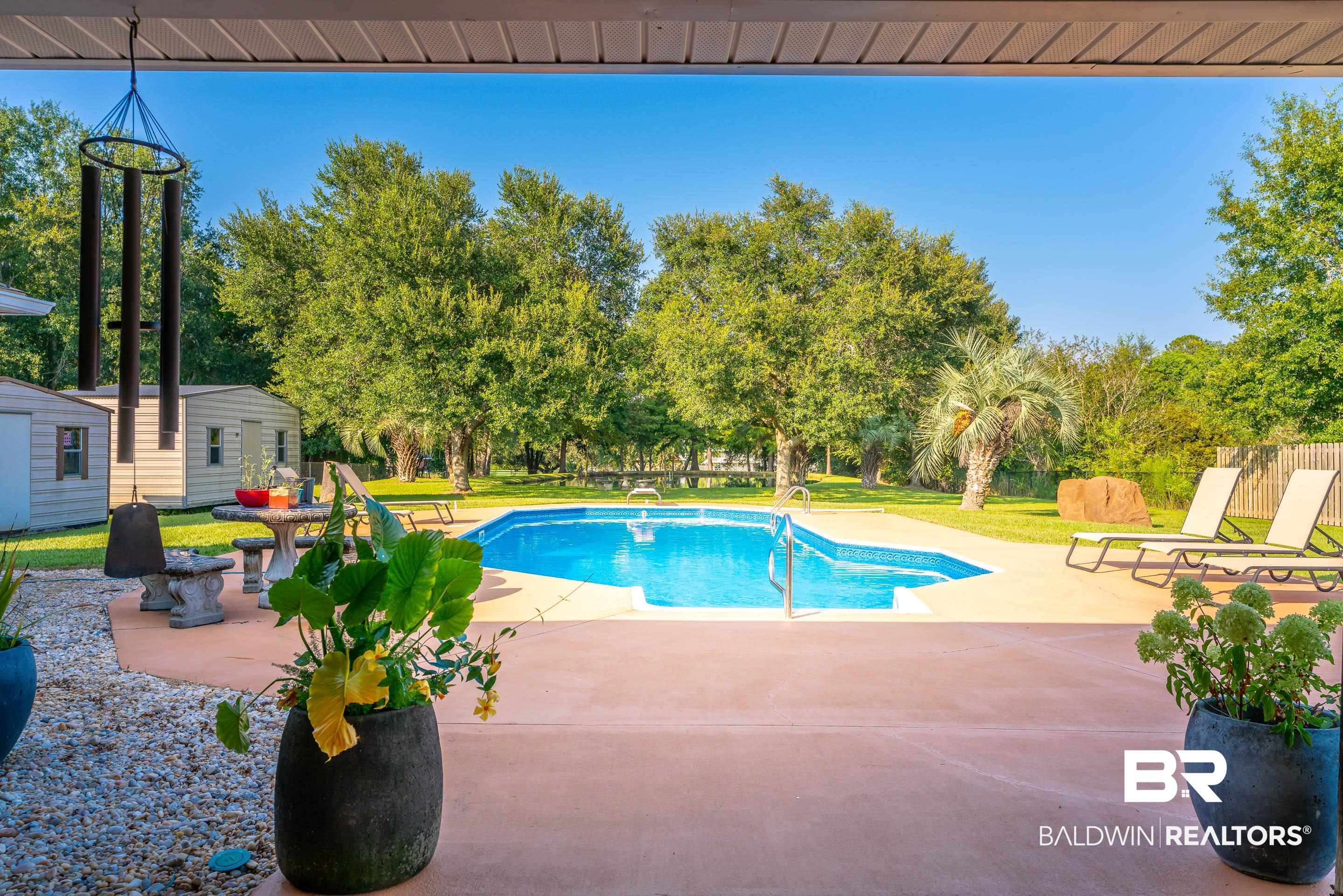 9477 Deerfield Drive Irvington, AL 36544 - Photo 37 of 58 View of swimming pool featuring a patio area, an outbuilding, and a lawn