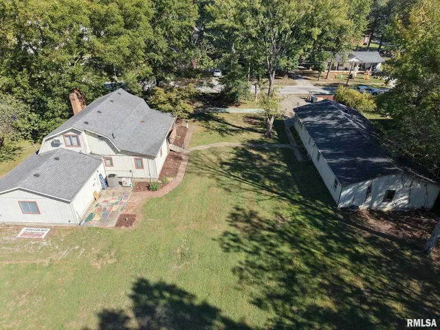 a view of a house with a yard and sitting area