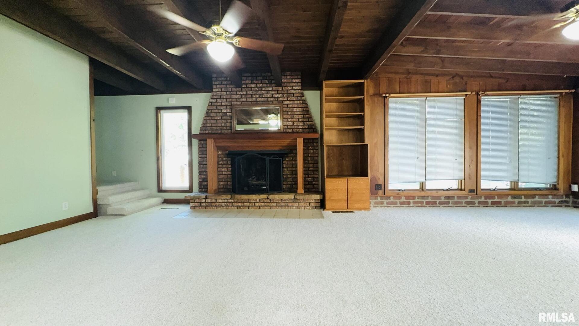601 1st Street Benton, IL 62812 - Photo 36 of 53 an empty room with fireplace and windows