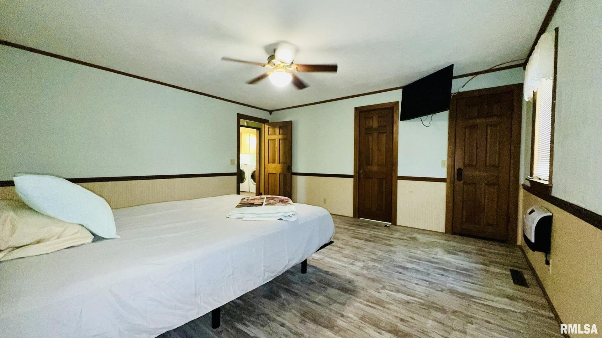 601 1st Street Benton, IL 62812 - Photo 40 of 53 a bedroom with a bed dresser and a large window