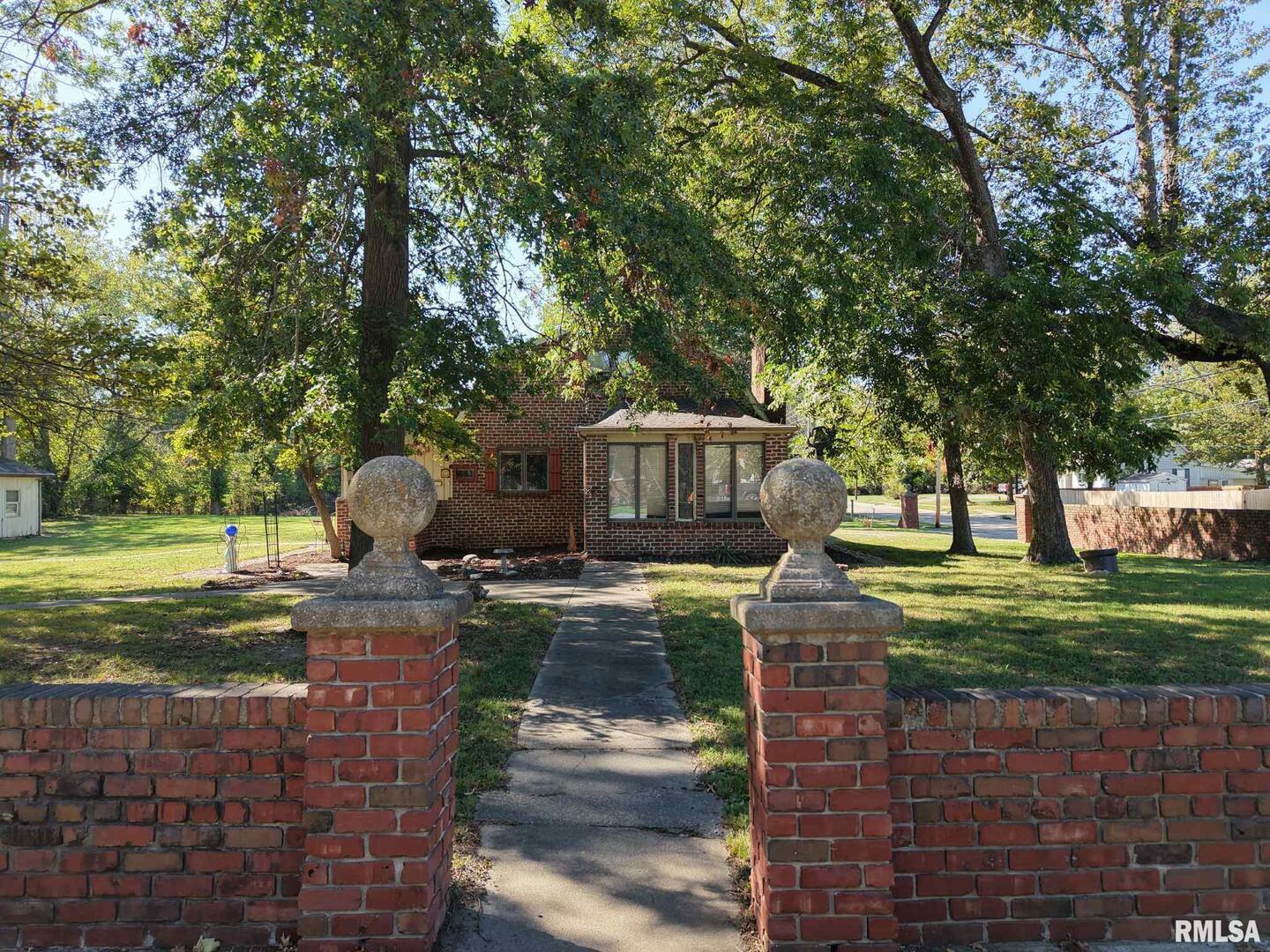 601 1st Street Benton, IL 62812 - Photo 5 of 53 a front view of a house with garden and trees