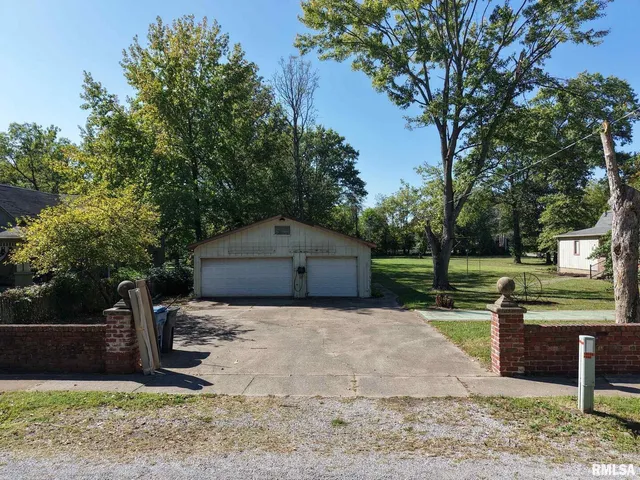 a house that has a tree in front of it