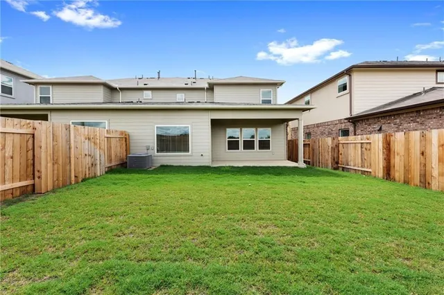 a view of a backyard with plants and a garden