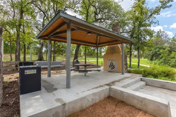a view of backyard with outdoor seating and trees