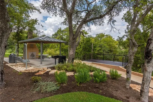 a view of a patio with table and chairs under an umbrella