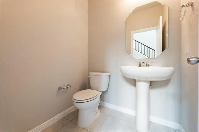 a bathroom with a sink toilet and a mirror