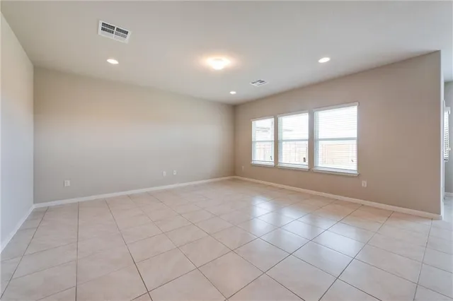 an empty room with windows and entrance