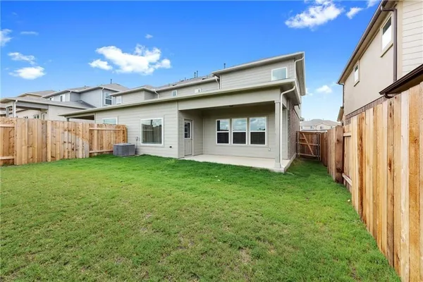 a view of a house with a backyard