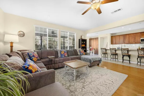 a open kitchen with stainless steel appliances granite countertop a lot of counter space and living room