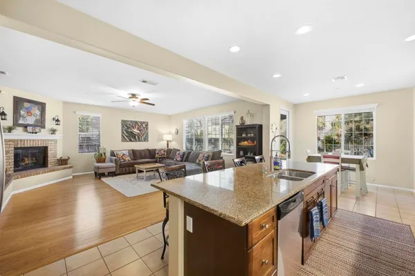 a large kitchen with stainless steel appliances granite countertop plenty wooden cabinets counter space and a sink